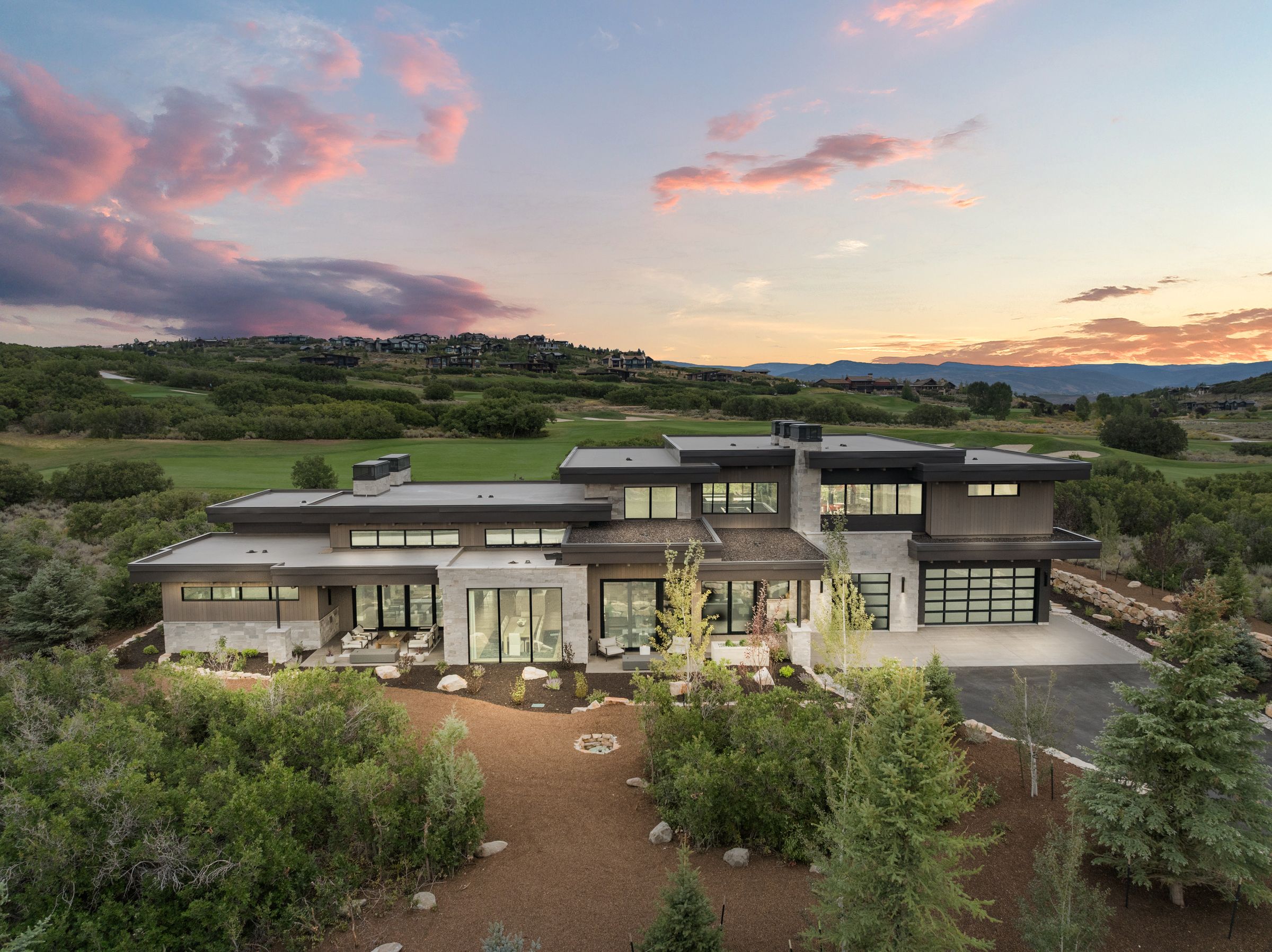 Aerial view of 2155 Adventure Way at sunset with the Uinta foothills beyond